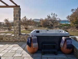 a bath tub sitting on top of a patio at Golden Beach Villa Paros in Chrissi Akti