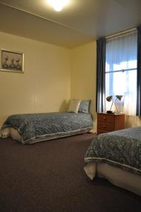 Ένα ή περισσότερα κρεβάτια σε δωμάτιο στο GreenGate Cottages