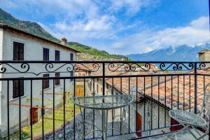 a balcony with a table and a view of mountains at Hotel Castello in Tignale