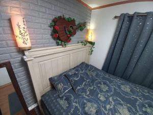 a bedroom with a bed and a wreath on the wall at Newly renovated hidden gem #2 in Seoul