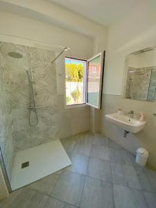 a bathroom with a shower and a sink at Tigrillo Bed&Breakfast in Olbia +46 photos