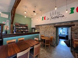 a restaurant with a wooden table and a bar at La Fattoria in Durham