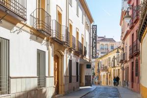 uma rua na cidade com pessoas andando pela rua em Hotel Macià Alfaros em Córdoba