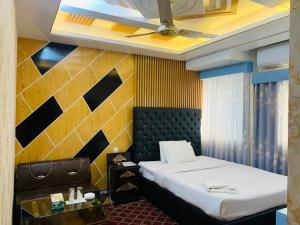 a bedroom with a bed and a ceiling fan at Hotel Heaven Inn in Dhaka