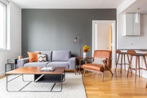 a living room with a couch and a table at Hells Kitchen 2BR w Pool DM nr Central Park NYC-469 in New York