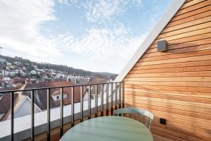 a balcony with a table and a view of a city at limehome Stuttgart Elsenhansstr in Stuttgart