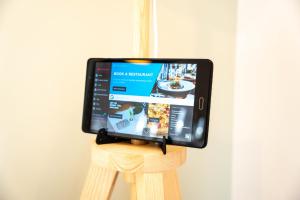 a tablet computer sitting on top of a wooden stand at Brookfield in Horley