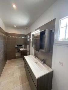 a bathroom with a white sink and a mirror at La Bastide Cezanne Natural elegance in Aix-en-Provence +8 photos