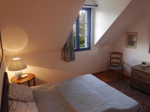 a bedroom with a bed and a chair and a window at Maison Le Palais, 5 pièces, 8 personnes - FR-1-418-3 in Le Palais