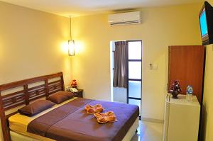 Säng eller sängar i ett rum på Guest House Matahari
