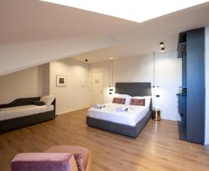 a large bedroom with a bed and a couch at San Carlo Suite Torino in Turin