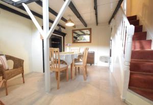 a dining room with a table and some chairs at Water's View Cottage, Hayle in Hayle