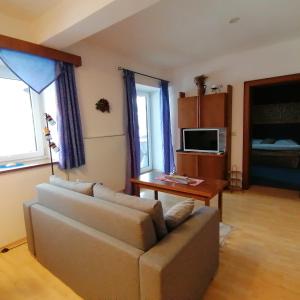 a living room with a couch and a table at Haus Hubertus in Hochfilzen