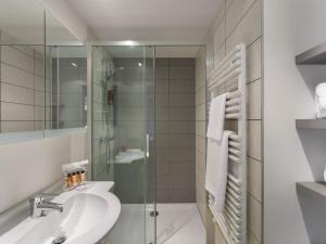 a bathroom with a sink and a glass shower at Studio Courchevel 1650, 2 pièces, 4 personnes - FR-1-563-117 in Courchevel