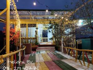 a balcony of a house at night with lights at Meliora Ba Vi Homestay in Ba Vì