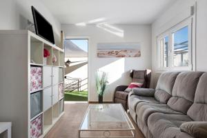 a living room with a couch and a glass table at Casa Rural El Abuelo in Chiclana de la Frontera