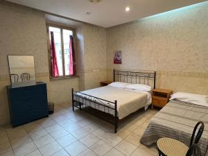 a bedroom with two beds and a table and chairs at Casa Vacanze Il Conservatorio - by Be Your Home in Civitavecchia