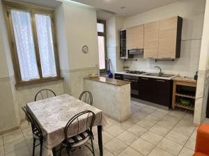 a kitchen with a table and a table and chairs at Casa Vacanze Il Conservatorio - by Be Your Home in Civitavecchia +23 photos