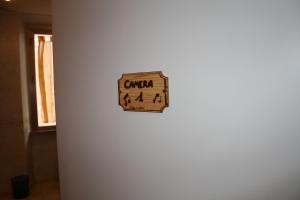una señal en el costado de una pared blanca en Be Your Home - Casa Vacanze Il Conservatorio, en Civitavecchia