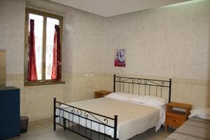 a bedroom with a bed and two windows at Casa Vacanze Il Conservatorio - by Be Your Home in Civitavecchia