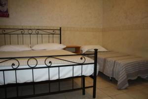 two beds in a room with two bedsskirts at Casa Vacanze Il Conservatorio - by Be Your Home in Civitavecchia