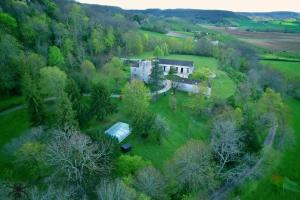 an aerial view of a house in a field with trees at Le Manoir De Bonal in Penne-dʼAgenais