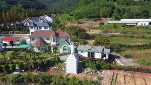 an aerial view of a house on a hill at Ever Rose Pension in Namhae