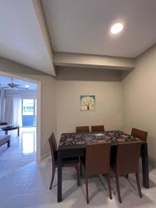 a dining room with a table and chairs at Perdana Serviced Apartment & Resorts in Kampung Padang Masirat