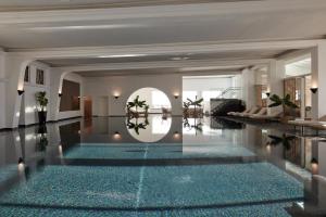 a lobby with a swimming pool with blue floors at TOP Hotel Hochgurgl in Hochgurgl