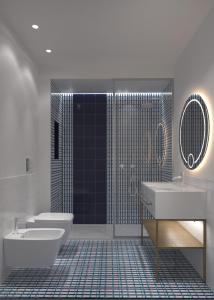 a bathroom with two sinks and a toilet and a shower at Grand Hotel Flora in Sorrento