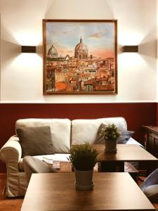 a living room with a couch and a painting on the wall at Residenza Sciarra Luxury Guest House in Rome