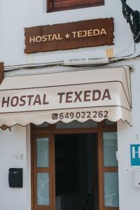 a sign for a hospital teedda on a building at Texeda Room Suites in Tejeda