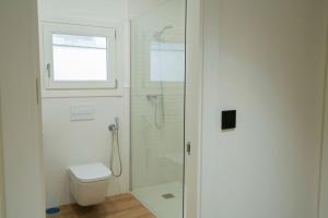 y baño blanco con ducha y aseo. en Suites Chinitas, en Málaga