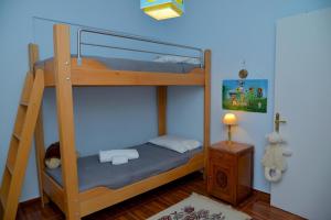 a bedroom with a bunk bed with a ladder at Ef Zin Villa by Corfuescapes in Sidari