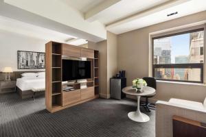 a hotel room with a bed and a tv at Hyatt Grand Central New York in New York