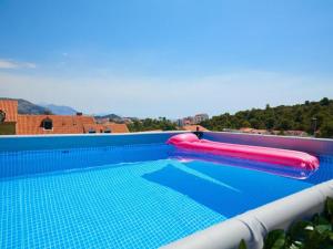 a swimming pool with two inflatables on top of it at Palm Tree Apartments in Dubrovnik