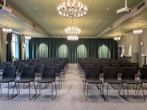 a conference room with black chairs and a chandelier at Statt Hassleholm BW Signature Collection in Hässleholm