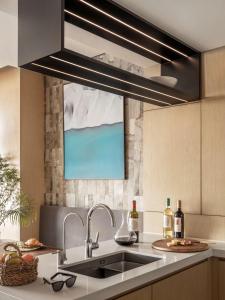 a kitchen with a sink and a large overhead light at East Beijing in Beijing