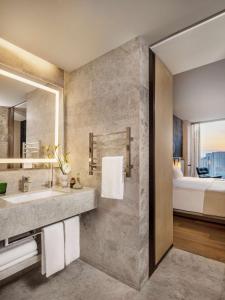 a bathroom with a sink and a bed at East Beijing in Beijing