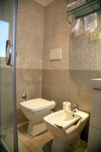 a bathroom with a toilet and a sink at Albergo Glory in Borghetto Santo Spirito