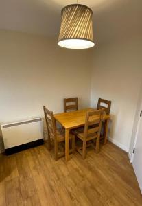 a dining room with a wooden table and chairs at One bedroom with Great city views in London