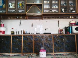 a kitchen with wooden cabinets and a counter top at Stanzin Home Stay in Leh