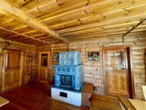 a room with a blue stove in a wooden room at Axterhütte 