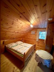 a bedroom with a bed in a wooden cabin at Axterhütte 