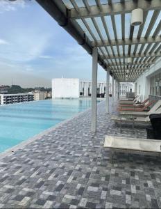 a swimming pool on the roof of a building at Shah Alam Tokma Servis Apartment in Shah Alam