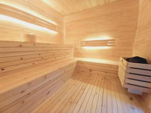 a sauna with wooden paneling and a wooden floor at Splash Rock Beachfront Villa in Umtentweni