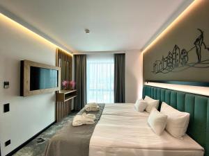 a hotel room with a bed and a flat screen tv at Focus Hotel Premium Bydgoszcz in Bydgoszcz
