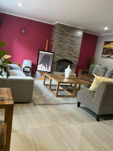 a living room with a couch and a fireplace at Phumula on St James in Johannesburg