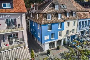 a blue building in the middle of a group of buildings at Hotel Max am See in Meersburg