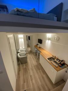 a room with a bed and a desk and a sink at Visavi' Luxury Room in Torre a Mare +35 photos